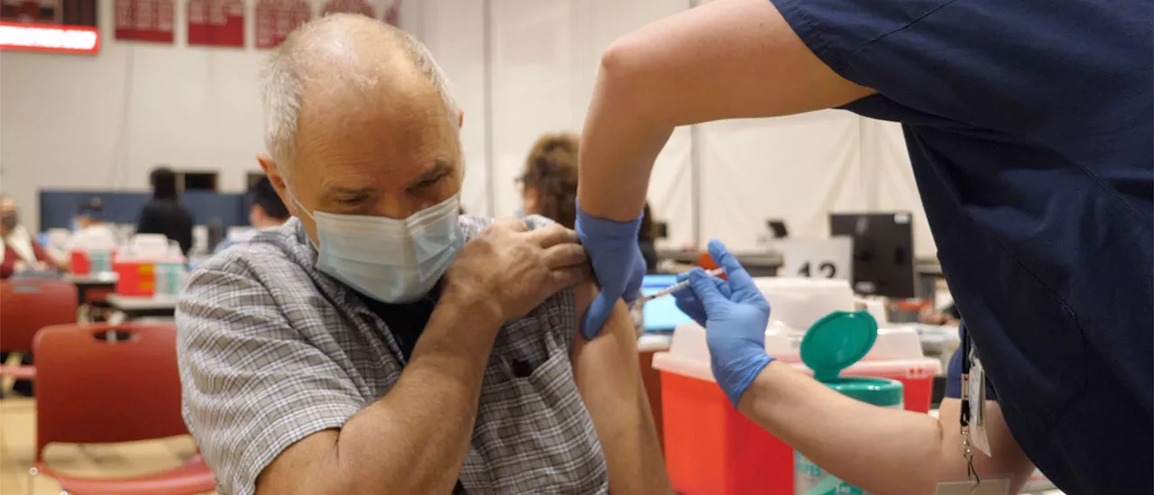 Community member getting COVID shot at state vaccination center on SUNY Oneonta campus