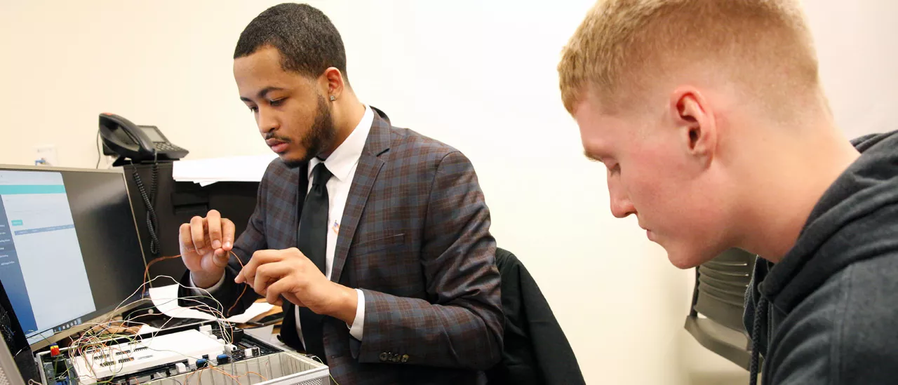 Students working together to wire a computer.