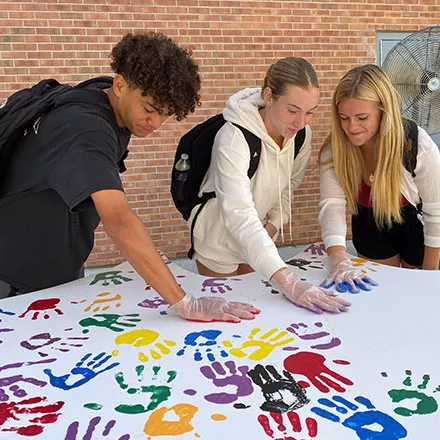 Students Place Hands on Wings