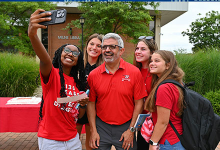 Dr Cardelle with student on red day taking a selfie